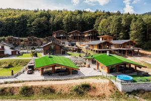 an aerial view of a resort with green roofs at Mountain Chalets Valča -hobitie domy in Stará Turá