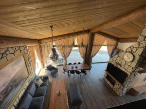 an overhead view of a living room with a table and chairs at Mountain Chalets Valča -hobitie domy in Stará Turá