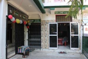 an entrance to a building with balloons and a door at Laxmi Lodge in Rishīkesh