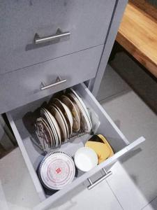 a drawer in a cabinet with dishes in it at Minimalist 2 bedroom house 