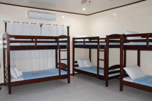 a room with three bunk beds in a room at Arapal Nature Retreat in Bogo
