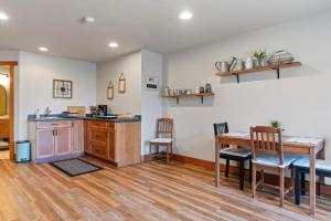 a kitchen and dining room with a table and chairs at Shawnigan Hills Guest Suite in Shawnigan Lake