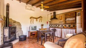 a living room with a table and a kitchen at La Huerta del Tajo - Pequeña Ronda by Ruralidays in Ronda