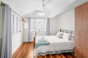 a bedroom with a bed and a window at Inner City Serenity in Cairns