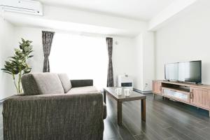 TV a/nebo společenská místnost v ubytování Sun Court Hondori Garden Hills + 53 fotografií