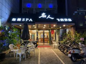 un restaurante con mesas y sillas frente a un edificio en Ming Ren Hotspring Hotel en Jiaoxi