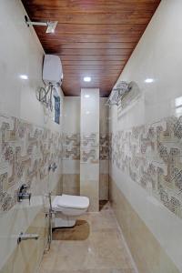 a bathroom with a toilet and a sink in it at Sun Inn Residency Rabale in Navi Mumbai