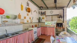 a kitchen with a sink and a counter top at El Castillejo Alpandeire by Ruralidays in Alpandeire