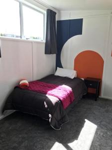 a bedroom with a bed in a room with a window at Farmland retreat in Tokoroa