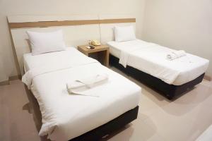 Postel nebo postele na pokoji v ubytování Lombok Mayura Hotel
