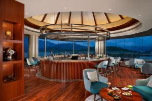 a bar in a room with chairs and tables at Taj Wayanad Resort & Spa, Kerala in Wayanad