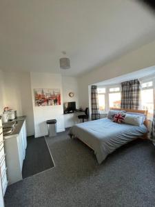 a bedroom with a bed and a kitchen in it at Fionn House Darlington in Darlington