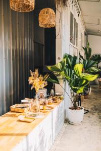 a table with plates of food and plants on it at The PARK Society in Chiang Mai