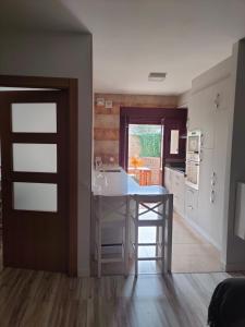 a kitchen with a white island in a room at THE HOME Hervás Plaza de garaje gratis in Hervás +13 photos