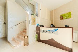 a reception area of a building with a staircase at Hotel Pacific in Timişoara