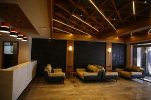 a lobby with couches and chairs in a room at Avana- A Boutique Hotel in Hyderabad