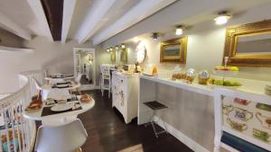 a restaurant with tables and chairs in a room at Dimora Bellini by Hotel Bellini sas in Palermo