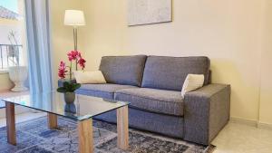 a living room with a couch and a glass table at Apartment Fontana Golf Villamartin in Orihuela Costa