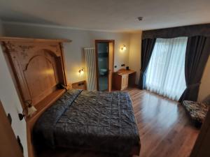 Voodi või voodid majutusasutuse Panorama Hotel Fontanella toas