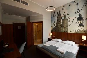 a bedroom with a bed with bats on the wall at Hotel Downtown Kraków in Krakow