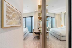 a hotel room with a bed and a desk and a bedroom at Lux BnB I The Address JBR I Ocean View in Dubai