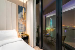 a bedroom with a view of the burj khalifa at Lux BnB I The Address JBR I Ocean View in Dubai