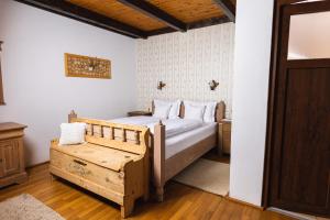 a bedroom with a bed and a chair in it at Casa Tirol Blaj in Blaj +90 photos