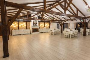 a large room with tables and chairs and a fireplace at Casa Tirol Blaj in Blaj