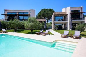 a swimming pool in front of a house at Elies Aesthetic Living in Iraklitsa
