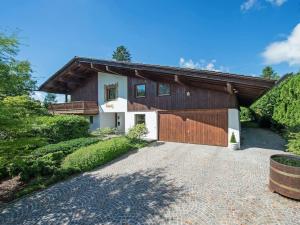 a house with a garage and a driveway at whole villa Munich, Alps view, Quiet and spacious in Feldkirchen-Westerham