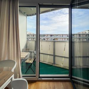 a room with a balcony with a view of a building at MyRoom Apartment in Munich in Munich