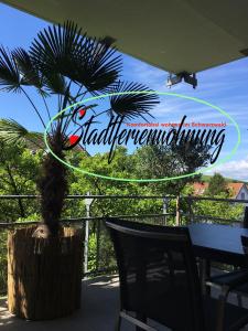 a sign for a restaurant with a palm tree at Stadtferienwohnung in Müllheim