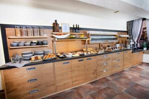 a kitchen with a buffet with food on it at Hotel Forsthaus in Winterberg