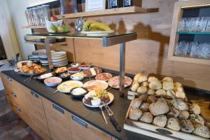a buffet with many different types of food on a counter at Hotel Forsthaus in Winterberg