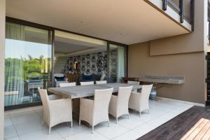 a dining room with a wooden table and chairs at Luxury 3 Bed Villa- Zimbali Coastal Resort Retreat in Ballito