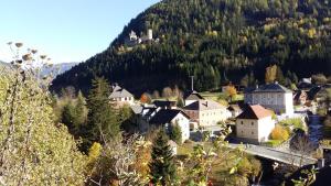 a small town in the mountains with a castle on a hill at Casa Ema Austria in Ramingstein