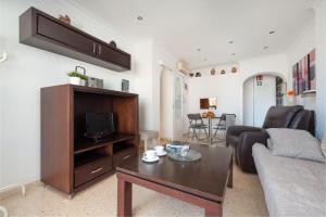 a living room with a couch and a table at Apartment Rovelló - Port d'Alcúdia in Port d'Alcudia