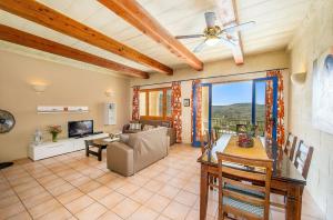 a living room with a ceiling fan and a couch at The Blue House Holiday Home in Għasri