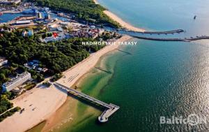 eine Luftansicht auf einen Strand und das Meer in der Unterkunft Apartamenty BalticON Nadmorskie Tarasy in Kołobrzeg