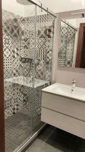 a bathroom with a shower and a sink at House of Bruno Apartments - NO Reception in Trento +13 photos