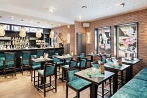 a restaurant with tables and chairs and a bar at Schlossberghotel Oberhof in Oberhof