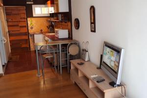 a living room with a tv and a table with a tv console at Sol y playa in Benalmádena
