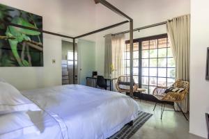 a bedroom with a bed and a table and chairs at Africa Lodge in Somerset West +80 photos