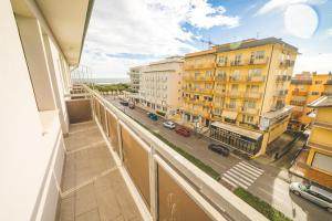 a balcony with a view of a street and buildings at Hotel Grand Prix in Sottomarina