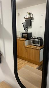 a mirror reflection of a kitchen with two microwaves at Bv Homely Studio Fourteen At Deighton Huddersfield in Huddersfield