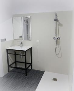 a bathroom with a sink and a mirror at Siaba Pensión Boutique in Sigüeiro
