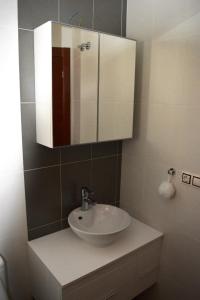 a bathroom with a white sink and a mirror at Casa Spa in Polop