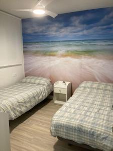 a room with two beds and a mural of the ocean at Octopus´Garden in La Herradura
