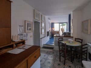 a kitchen with a table and chairs and a dining room at Apartment Lo Scuopolo-2 by Interhome in Ischia