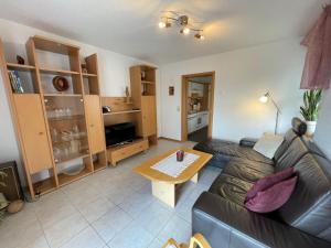 a living room with a couch and a table at Apartment Janik by Interhome in Bischofsmais